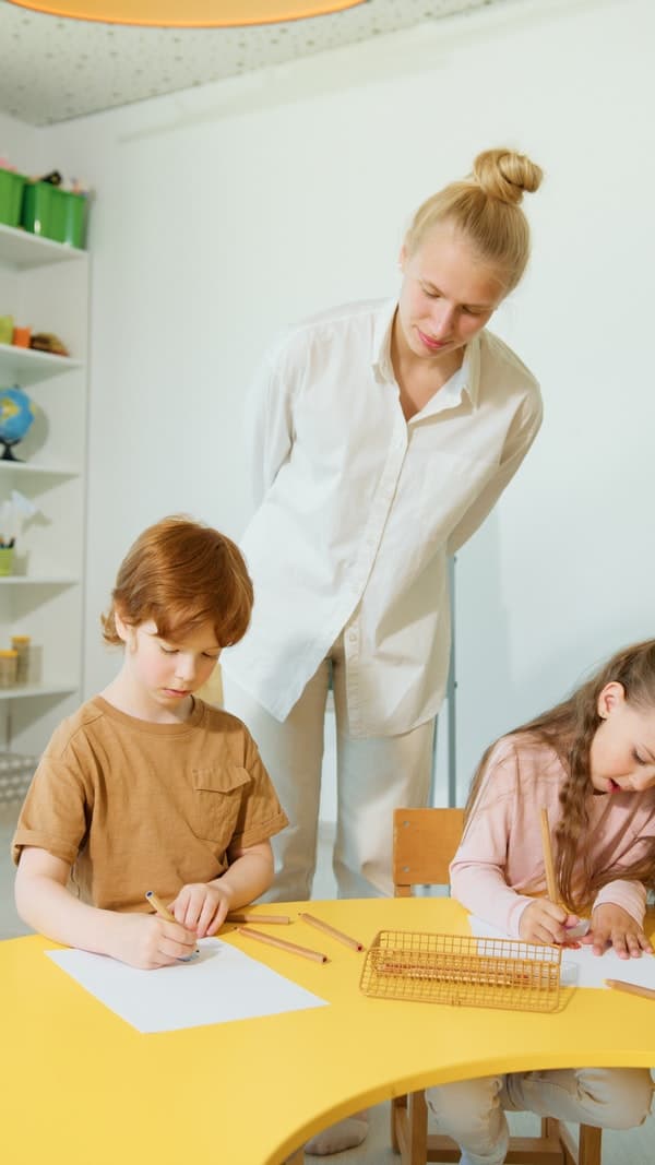 Learning Steps tutor working one-on-one with young students